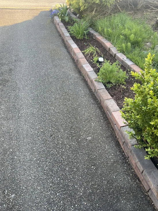 Customer using weed spray around driveway and paver areas